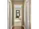 Hallway view showcases the transition to a Primary bathroom with mirror and vanity area at 113 Blackwater Way, Moncks Corner, SC 29461