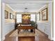 Spacious office with wooden desk, statement lighting, and ample natural light from large windows at 113 Blackwater Way, Moncks Corner, SC 29461
