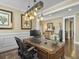 Sophisticated home office featuring a wooden desk, elegant decor, and unique lighting fixture at 113 Blackwater Way, Moncks Corner, SC 29461