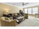 Spacious living room with sofa, armchairs, ceiling fan, and ample natural light at 113 Blackwater Way, Moncks Corner, SC 29461