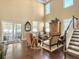 Bright living room featuring high ceilings, dark wood floors, and a staircase at 113 Blackwater Way, Moncks Corner, SC 29461