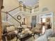 Inviting living room showing the staircase, tall windows, and hardwood floors at 113 Blackwater Way, Moncks Corner, SC 29461