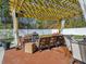 Inviting outdoor patio features an elegant seating area with overhead pergola and privacy fence at 113 Blackwater Way, Moncks Corner, SC 29461