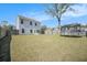 Expansive backyard with lush lawn, patio set, and trampoline, perfect for outdoor activities and relaxation at 1132 Mossy Rock Dr, Summerville, SC 29485