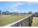Scenic backyard with a serene pond view, providing a tranquil and picturesque setting with neighborhood at 1132 Mossy Rock Dr, Summerville, SC 29485