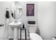 A half bathroom with a pedestal sink, oval mirror, and toilet at 1132 Mossy Rock Dr, Summerville, SC 29485