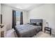 Comfortable bedroom featuring a gray bed, dark curtains, and neutral decor at 1132 Mossy Rock Dr, Summerville, SC 29485
