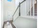 Bright foyer with staircase and natural light, featuring wood flooring and a view of the entrance door at 1132 Mossy Rock Dr, Summerville, SC 29485
