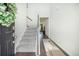 Inviting foyer with a carpeted staircase, wood floors, and a view into the main living area at 1132 Mossy Rock Dr, Summerville, SC 29485