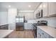 Bright kitchen with stainless steel appliances, granite countertops, white cabinets, and tile backsplash at 1132 Mossy Rock Dr, Summerville, SC 29485