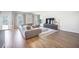 Bright living room featuring a modern sectional, stylish rug, and large windows providing natural light at 1132 Mossy Rock Dr, Summerville, SC 29485