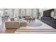 Bright living room featuring a modern sectional, stylish rug, and large windows providing natural light at 1132 Mossy Rock Dr, Summerville, SC 29485