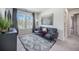 Comfortable sitting area with a gray sofa, rug, and large windows bringing in lots of natural light at 1132 Mossy Rock Dr, Summerville, SC 29485
