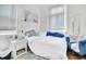 Cozy bedroom with natural light featuring a comfortable bed, blue accents, and a nightstand with storage at 125 Ashley Ave, Charleston, SC 29401