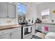 Bright kitchen features grey cabinets, butcher block countertops, stainless steel appliances, and white wood paneled walls at 125 Ashley Ave, Charleston, SC 29401