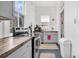 Bright kitchen features grey cabinets, butcher block countertops, stainless steel appliances, and white wood paneled walls at 125 Ashley Ave, Charleston, SC 29401