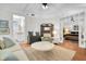 Open living room with hardwood floors and views into the kitchen and bedroom at 125 Ashley Ave, Charleston, SC 29401