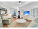 Cozy living room with hardwood floors, comfortable seating, and views into the bedroom at 125 Ashley Ave, Charleston, SC 29401