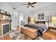 Bright main bedroom with a ceiling fan, fireplace, and a cowhide rug at 125 Ashley Ave, Charleston, SC 29401