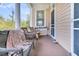 Inviting front porch with wicker furniture and neutral colors at 125 Ashley Ave, Charleston, SC 29401