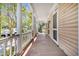 Spacious covered porch with wooden flooring and classic white columns at 125 Ashley Ave, Charleston, SC 29401