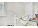 Staircase with white painted wood railing, a colorful carpet runner and light from a window at 125 Ashley Ave, Charleston, SC 29401