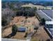 Aerial view of a single Gathering home and lot with mature trees and a large yard in an industrial area at 126 N Hwy 52, Moncks Corner, SC 29461