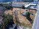 Aerial view of home surrounded by a spacious yard near a road and a mobile home community at 126 N Hwy 52, Moncks Corner, SC 29461