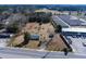 Aerial view of a single Gathering home and lot with mature trees and a large yard in an industrial area at 126 N Hwy 52, Moncks Corner, SC 29461