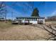 Backyard view of a single story white home with a large deck and backyard at 126 N Hwy 52, Moncks Corner, SC 29461