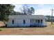 A single story white home with a gray roof and a small porch and front yard at 126 N Hwy 52, Moncks Corner, SC 29461