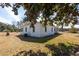 A single story white home with a gray roof and a small yard at 126 N Hwy 52, Moncks Corner, SC 29461