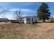 The back exterior of a quaint single story house with a wooden deck and a well-maintained lawn at 126 N Hwy 52, Moncks Corner, SC 29461