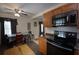 Charming kitchen with wood cabinets, modern black appliances, and a ceiling fan for added comfort at 126 N Hwy 52, Moncks Corner, SC 29461