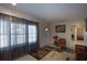Well-lit living room featuring large windows, tile floors, and comfortable seating, perfect for relaxation and gatherings at 126 N Hwy 52, Moncks Corner, SC 29461