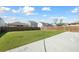 Spacious, fenced backyard with lush green grass and a concrete patio area at 1309 Berry Grove Dr, Summerville, SC 29485