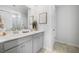 Bathroom with double sink vanity and a large mirror, neutral paint and tile floors at 1309 Berry Grove Dr, Summerville, SC 29485