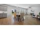 Open dining area with views of the backyard, hardwood floors, and modern light fixtures at 1309 Berry Grove Dr, Summerville, SC 29485