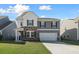 Charming two-story home with a two-car garage, stone accents, and a well-manicured lawn at 1309 Berry Grove Dr, Summerville, SC 29485