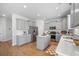 Modern kitchen with stainless steel appliances, white countertops, and gray cabinets at 1309 Berry Grove Dr, Summerville, SC 29485