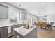 Bright kitchen featuring gray cabinets, stainless appliances, and an island with marble countertops at 1309 Berry Grove Dr, Summerville, SC 29485