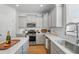 Modern kitchen with stainless steel appliances, white countertops, and gray cabinetry at 1309 Berry Grove Dr, Summerville, SC 29485
