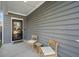 Inviting covered porch with two chairs and a side table, showcasing the home's exterior at 1309 Berry Grove Dr, Summerville, SC 29485