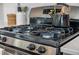 Stainless steel gas stove top with black accents and a stainless steel kettle on top at 1309 Berry Grove Dr, Summerville, SC 29485