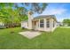 Charming backyard showcasing a patio area and a sunroom with lots of windows at 1312 Belle Grove Cir, Hanahan, SC 29410