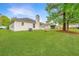 Spacious backyard with lush green grass and mature trees offering shade and privacy at 1312 Belle Grove Cir, Hanahan, SC 29410