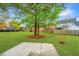 Large, grassy backyard featuring mature trees and a concrete patio area, perfect for outdoor entertaining at 1312 Belle Grove Cir, Hanahan, SC 29410
