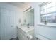 Well-lit bathroom featuring a vanity, mirror with lights, neutral walls, and white door at 1312 Belle Grove Cir, Hanahan, SC 29410