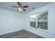 Cozy bedroom with a ceiling fan, two windows, and gray flooring at 1312 Belle Grove Cir, Hanahan, SC 29410