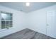 A cozy bedroom with modern vinyl flooring, a window letting in natural light and white walls at 1312 Belle Grove Cir, Hanahan, SC 29410